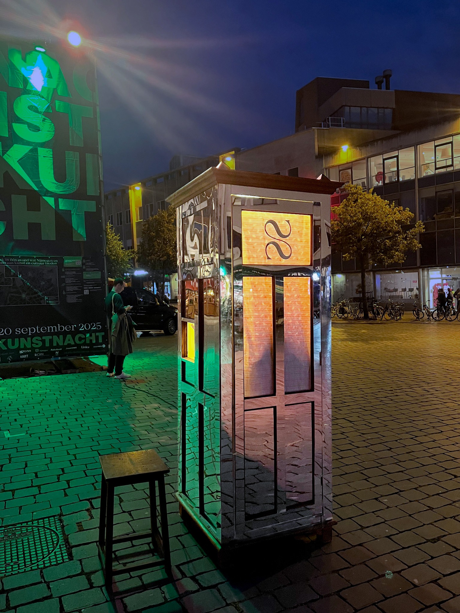 Mirrored booth illuminated at night