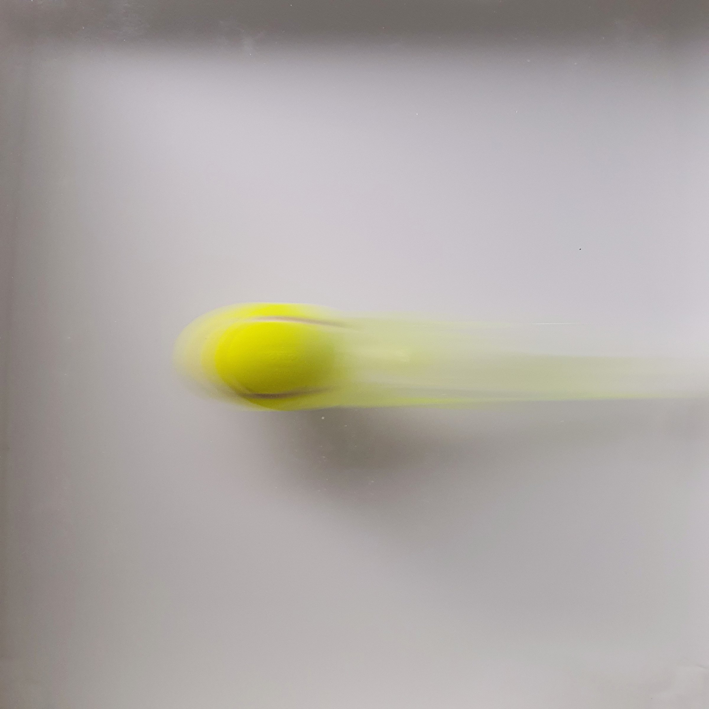 Close view of a yellow ball in motion