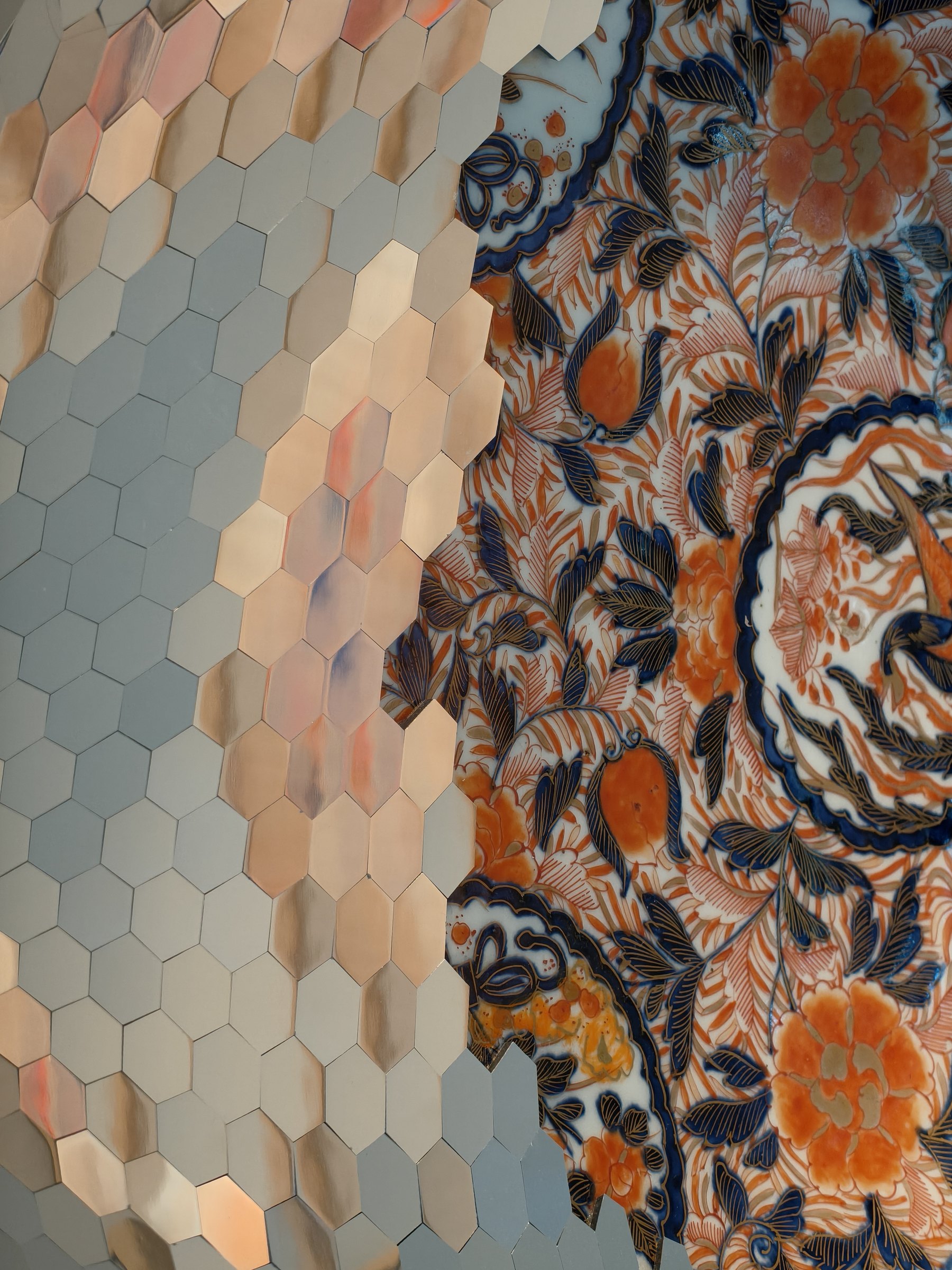 Detail of reflective hexagons meeting painted porcelain